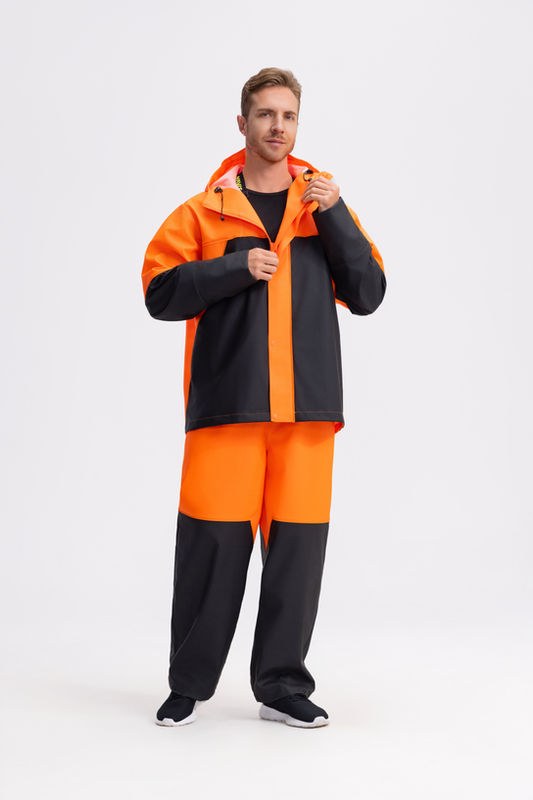 Worker wearing orange and black rain gear
